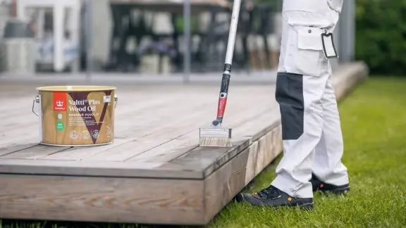 Painter oiling a terrace