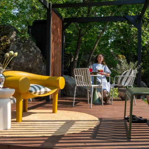 Varjoisa terassi, jossa keltainen tuoli