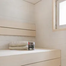 Vaalea moderni sauna, joka on vahattu valkoisella Supi Saunavahalla