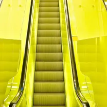 Keltaisella maalattu liukuportaiden käytävä