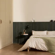 Makuuhuone kuultavalla tummanvihreällä seinäpaneelilla