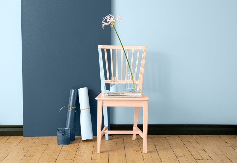 light pink beige chair in front of blue wall